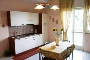 A kitchen or kitchenette at Appartamento Raffaella
