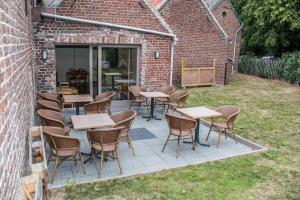 a patio with tables and chairs in a yard at Jules place in Wakken