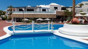 a pool at a resort with a slide at Los Cardones Boutique Village in Playa de las Americas