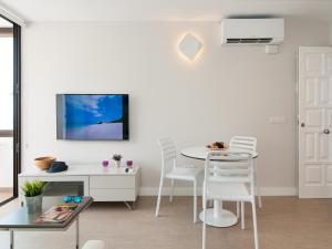 A television and/or entertainment centre at Beachfront Apartment Siesta 21 San Agustin Playa by VillaGranCanaria