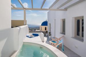 a villa with a plunge pool and a balcony at Altemar Suites in Fira