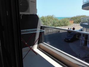 a balcony with a window with a view of a patio at Апартамент Дарко in Pomorie
