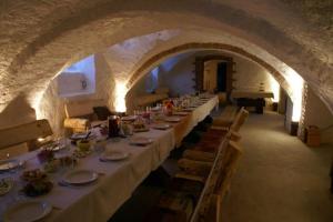 a group of tables in a room with an archway at Guesthouse Kadrina Mõis in Kadrina