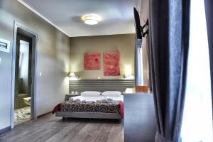 a bedroom with a bed and a large mirror at Melina Hotel - Central in Poligiros