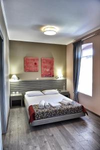 a bedroom with a large bed and a window at Melina Hotel - Central in Poligiros