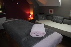 a bedroom with two beds with towels on them at A l'ombre du noyer in Fernelmont