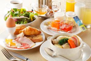 a table with plates of food and eggs on it at One Niseko Resort Towers in Niseko