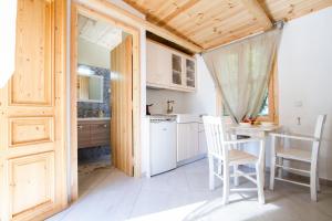 a kitchen with a table and chairs in a room at Mera Beachfront House - Falasarna in Falasarna