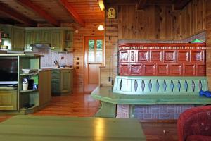 a kitchen with green cabinets and a counter in a cabin at Natural Wooden Sweetheart in Padeški Vrh