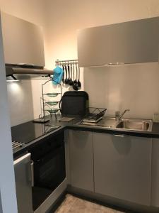 a kitchen with a sink and a counter top at Vue mer à Arromanches in Arromanches-les-Bains
