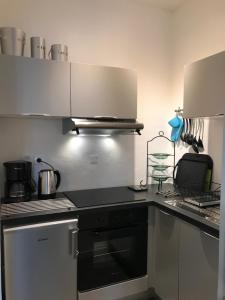 a kitchen with a stove and a counter top at Vue mer à Arromanches in Arromanches-les-Bains