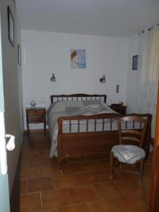 a bedroom with a bed and a table and a chair at Chambres d'Hôtes Le Baou in Annot