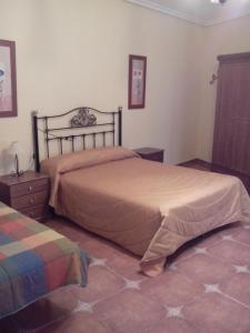 a bedroom with a large bed and a dresser at El Balcón de la Mancha in Tembleque