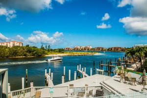 a boat in the water next to a dock at The BoatHouse in Marco Island