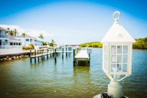 a lantern on the end of a dock in the water at The BoatHouse in Marco Island