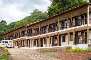 a building with balconies on the side of it at Hotel La Montaña San Gil in San Gil