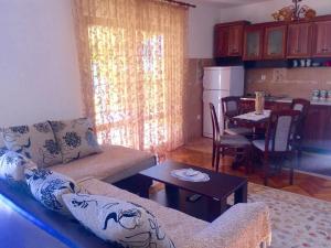 a living room with a couch and a table at Holiday Home Gazevic in Virpazar