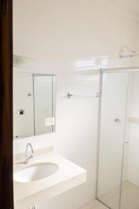 a bathroom with a sink and a glass shower at Hotel Municipal in Jaboticabal +48 photos
