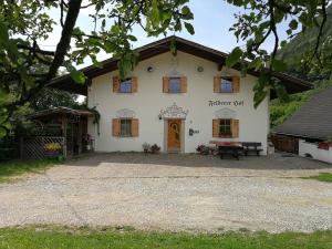 a white house with a bench in front of it at Feldererhof in Siusi