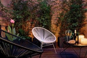 a room with two chairs and a table with wine glasses at Suite735 in Venice