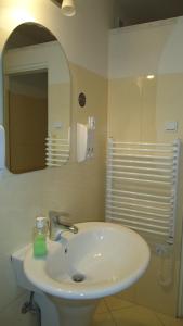 a bathroom with a white sink and a mirror at La Guitarra Hostel Gdańsk in Gdańsk +44 photos