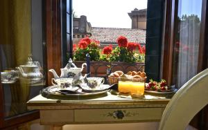 - une table avec de la nourriture et du thé sur un balcon dans l'établissement Alla Corte Rossa, à Venise