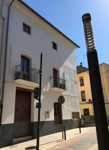 a white building with two balconies on a street at Casa Rural Xàtiva in Xàtiva