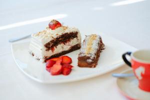 three pieces of cake on a plate with strawberries at Berggasthof Pension Pfitscher in Unsere Liebe Frau im Walde