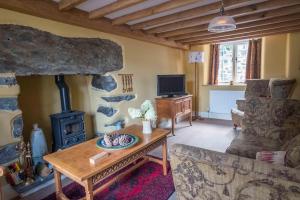 a living room with a fireplace and a stove at Plas Gwyn B&B and Holiday Cottage in Dolgellau