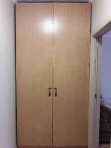 a wooden door with two handles on a wall at Apartments Kharkivs'ke highway in Kyiv