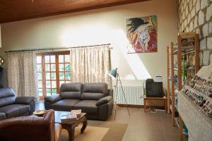 a living room with a couch and a tv at Casa De Crespins Casa de Campo Lda in Cristelo