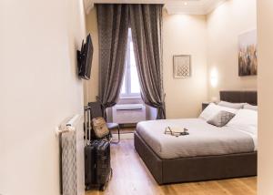 A bed or beds in a room at Nazionale Palace Suites