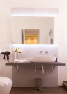 a bathroom with a sink and a mirror at Nazionale Palace Suites in Rome