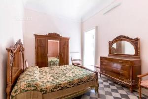 a bedroom with a bed and a dresser and a mirror at Casa Santa Barbara in Modica