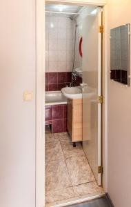 a bathroom with a tub and a sink at Vilnius Centre Flat in Vilnius