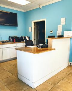 an office with a white counter and blue walls at Sea and Breeze Hotel and Condo in Tybee Island