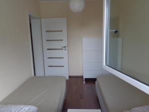 Posteľ alebo postele v izbe v ubytovaní Apartament Nadmorski Jelitkowo