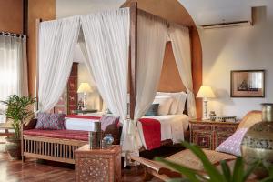 a bedroom with a canopy bed and a couch at Zorah Beach Hotel in Trairi +71 photos