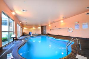 a large swimming pool in a hotel room at Baymont by Wyndham Grand Forks in Grand Forks
