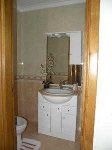 a bathroom with a sink and a toilet at AS 3 GAIVOTAS in Vila Praia de Âncora