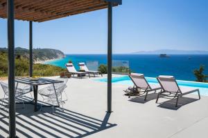 a patio with chairs and a table next to a pool at Casa di mare in Svoronata