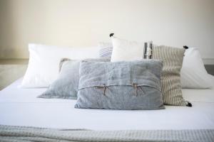 a bed with white sheets and pillows on it at Casa di mare in Svoronata