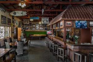 a restaurant with a bar and tables and chairs at Horsepower Ranch in Ensenada