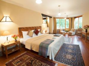 a bedroom with a large bed and a living room at Willka T'ika in Urubamba