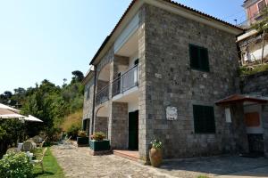 a brick building with a balcony and a patio at Villevieille in Piano di Sorrento