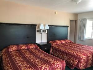 
a hotel room with two beds and two night stands at Townhouse Motel in Weed
