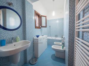 a bathroom with a sink and a toilet and a mirror at Nel Cuore Del Salento in San Donato di Lecce +30 photos