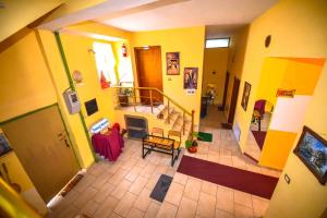 an overhead view of a living room with yellow walls at Pemaj Hostel in Shkodër