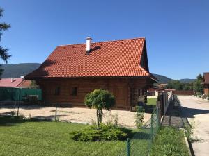 
a small house with a tree in front of it at Chata Eden in Hrabušice
