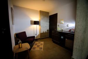 a hotel room with a chair and a sink at Maria Ines Hotel Suite in Oaxaca City